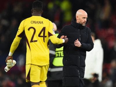 Manchester United's Dutch manager Erik ten Hag shakes hands with Manchester United's Cameroonian goalkeeper #24 Andre Onana after the UEFA Champions League group A football match between Manchester United and FC Bayern Munich at Old Trafford stadium in Manchester, north west England, on December 12, 2023. (Photo by PETER POWELL / AFP)